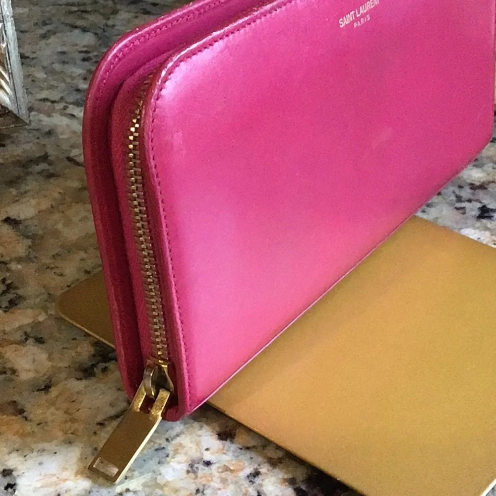Saint Laurent. pink zippy lambskin wallet gold tone hardware